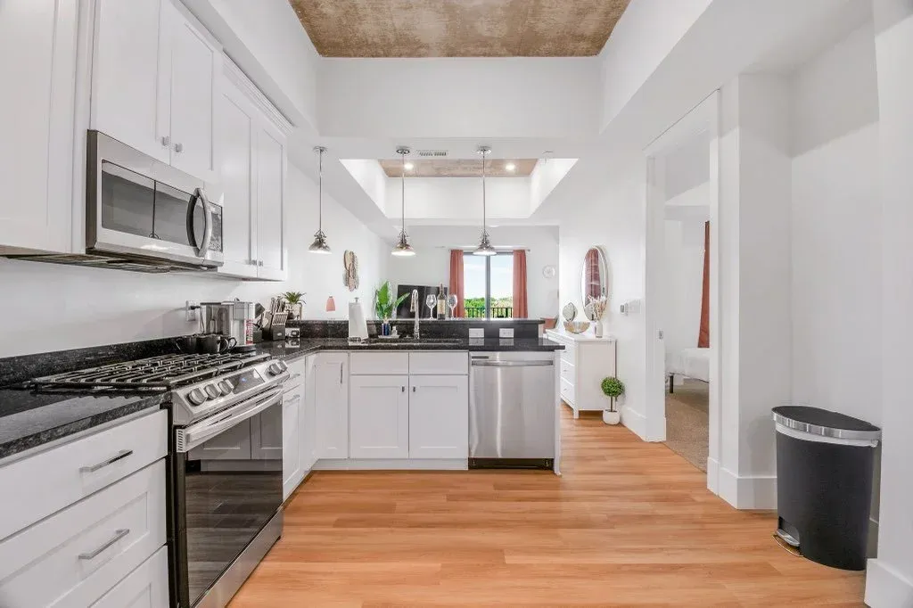 A sunny kitchen with stainless steel appliances and granite counters